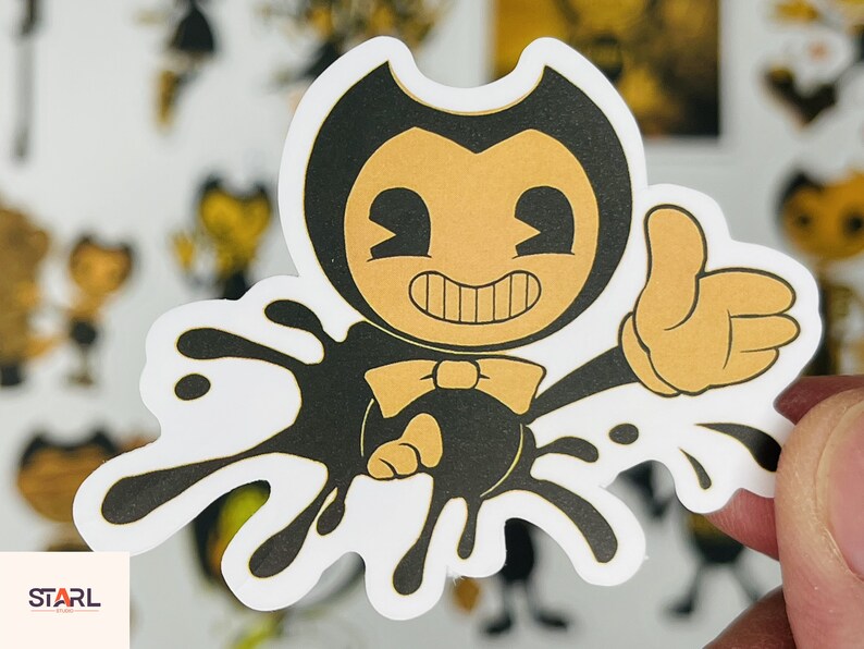 May include: A black and yellow cartoon character with a bow tie and a big grin, standing in a black ink splatter. The character is wearing a black suit and has large, white eyes.