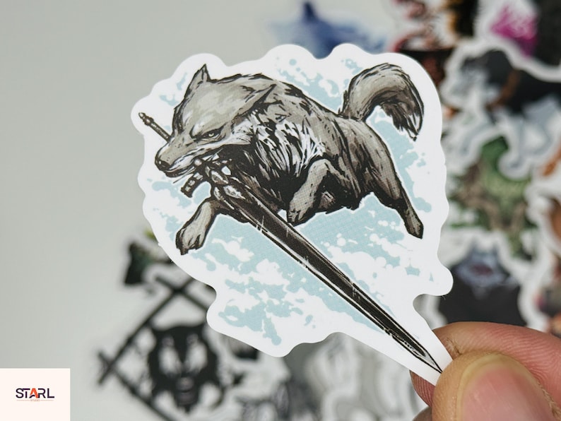 May include: A sticker featuring a gray wolf with a sword in its mouth, running across a light blue background. The wolf is detailed with black and white shading. The sticker has a white border and is surrounded by other stickers.