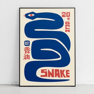 Peut inclure: Une affiche bleue et rouge avec un motif de serpent stylisé. Le texte "20g Balm" et "Snake" sont en rouge. Le texte "蛇香油" est en rouge et en caractères chinois.