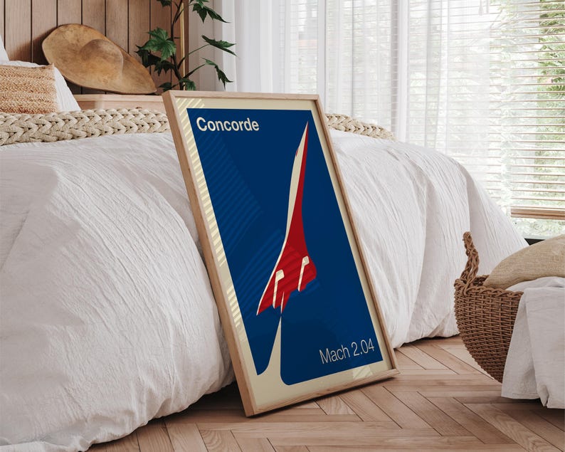 May include: A framed poster with a blue background and a red and white silhouette of the Concorde supersonic jet. The text "Concorde" and "Mach 2.04" are printed on the poster.