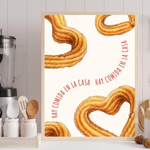 May include: A white background with the text "Hay comida en la casa" in red. The background is decorated with four churros, two of which are shaped like hearts.