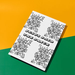 May include: White card with black floral designs and the text "JESUS PAID THE PRICE" in bold, black letters. The card is on a yellow and green background.