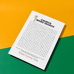 May include: A white card with a church word search puzzle. The card has a brown cross at the top and the words "Church Word Search" in black text. The puzzle is filled with letters and the words "Jesus Loves You" are printed at the bottom of the card.