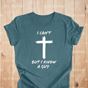May include: Teal blue t-shirt with a white cross and the text "I can't but I know a guy".