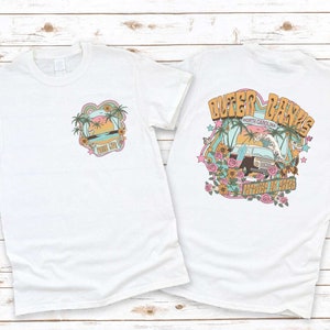 a couple of white shirts sitting on top of a wooden floor