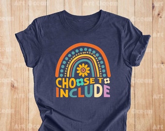 May include: A navy blue t-shirt with a rainbow graphic and the text "CHOOSE TO INCLUDE". The rainbow is made up of orange, yellow, green, blue, and purple stripes with white polka dots. There are two yellow flowers on the rainbow.