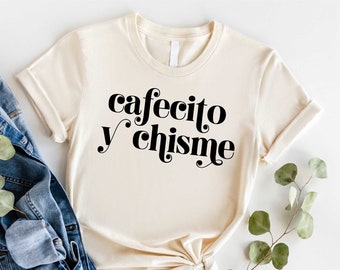 May include: A beige t-shirt with the text "cafecito y chisme" printed in black.
