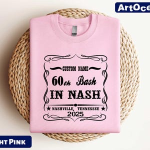 a pink t - shirt with a black print on it