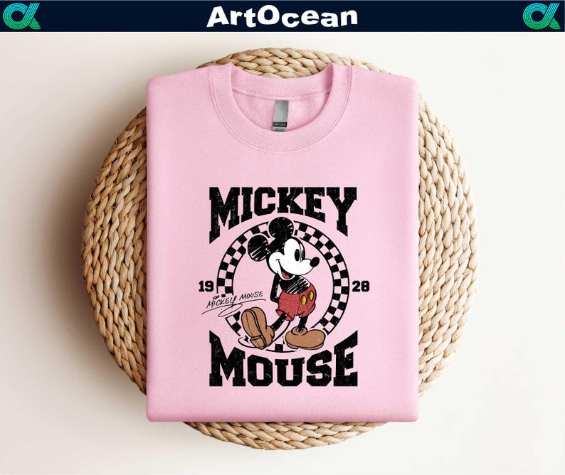 a pink mickey mouse shirt sitting on top of a basket