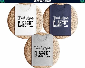May include: Three t-shirts with the text "Travel Agent Life" printed on them. The shirts are white, navy blue, and heather grey.