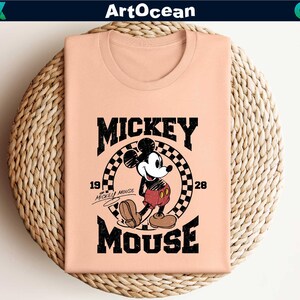 a pink shirt with mickey mouse on it