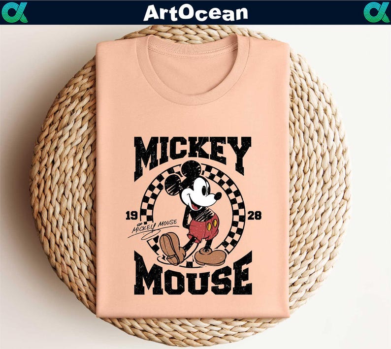 a pink shirt with mickey mouse on it