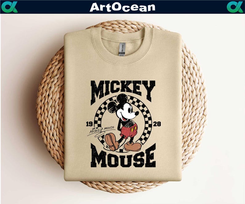 a mickey mouse t - shirt hanging on a wall