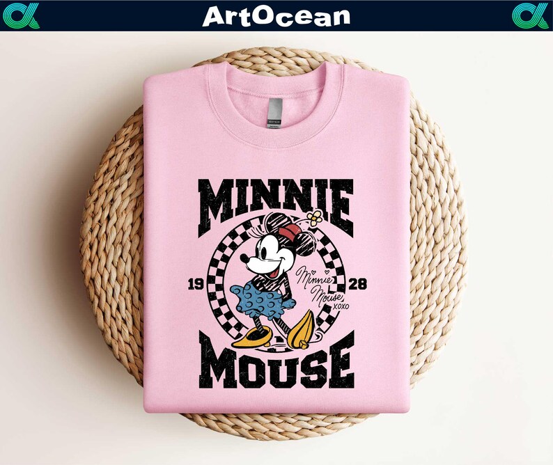 a pink shirt with a mickey mouse graphic on it