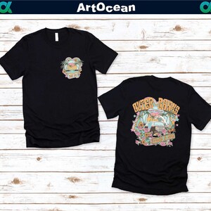 a couple of black shirts sitting on top of a wooden floor