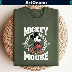 a mickey mouse t - shirt sitting on top of a basket