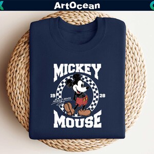 a mickey mouse t - shirt sitting on top of a basket