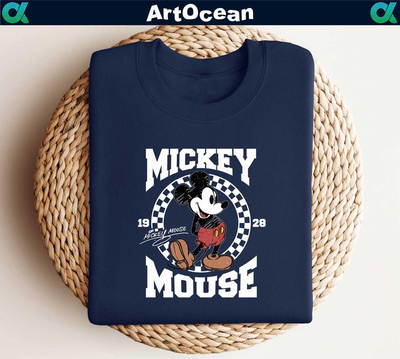 a mickey mouse t - shirt sitting on top of a basket