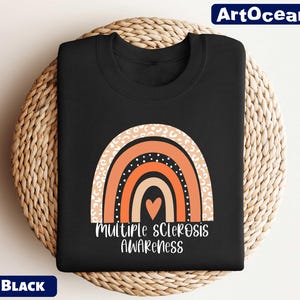 a black t - shirt with an orange and white rainbow on it