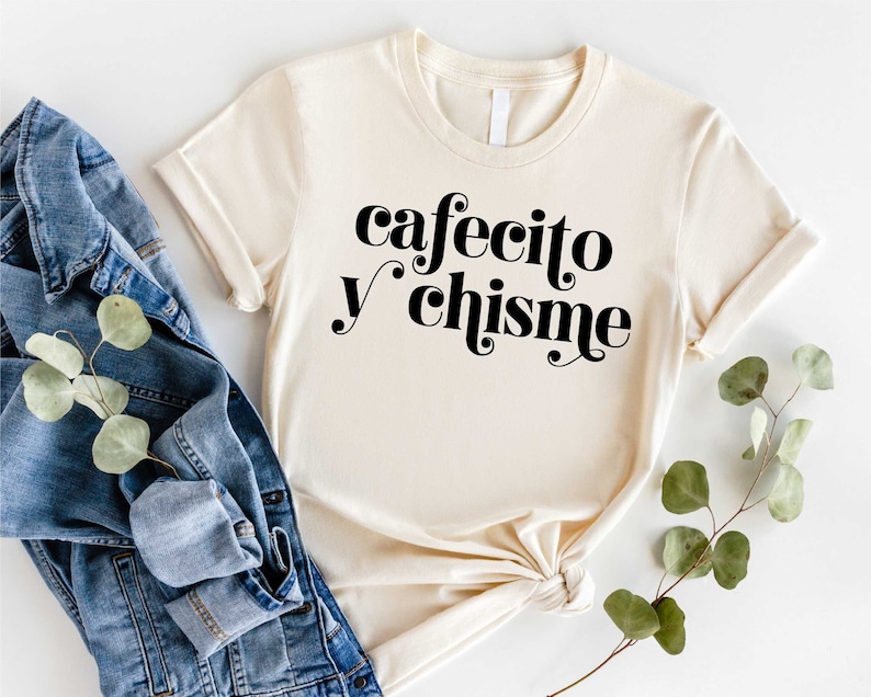 a t - shirt that says cafeto y chisine next to a pair