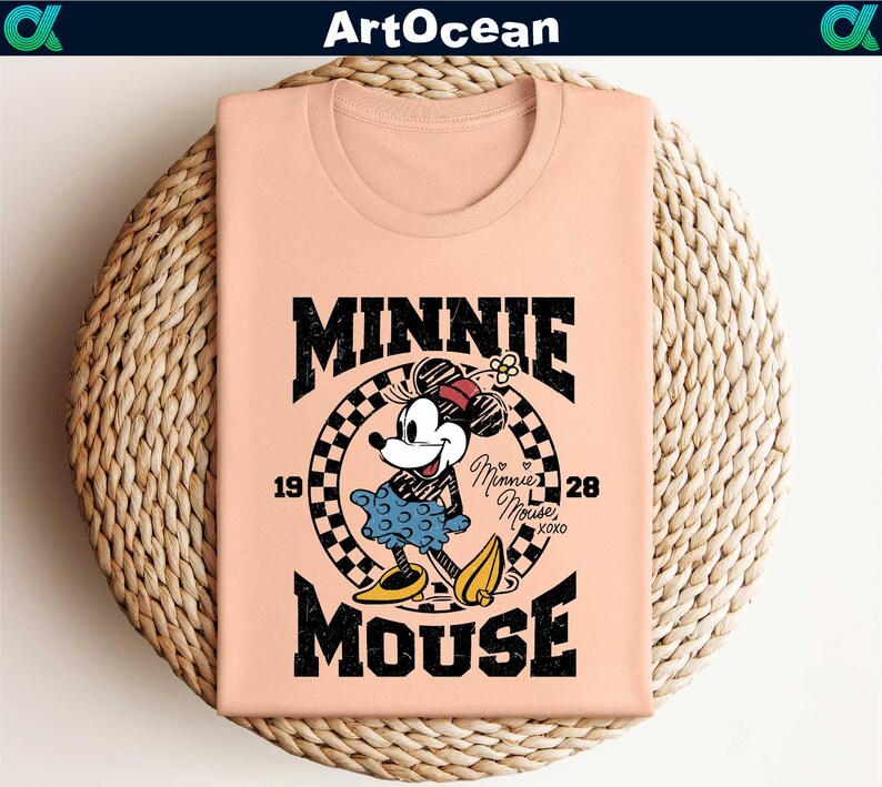 a pink shirt with a mickey mouse graphic on it