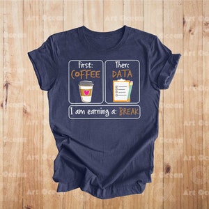 May include: A navy blue t-shirt with a white graphic that says "First: Coffee, Then: Data, I am earning a: Break". The graphic includes a cartoon coffee cup and a checklist with a pencil.