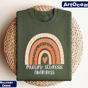 a green t - shirt with a rainbow and the words multiple scrabbles