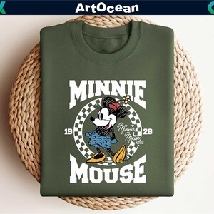 a green shirt with a mickey mouse graphic on it