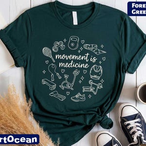 a green t-shirt with a white graphic design, a pair of sneakers, a cup of coffee, and some plants.