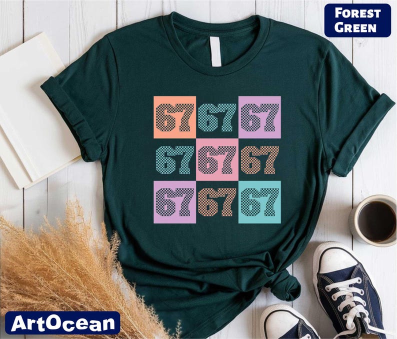 a green t-shirt with a colorful graphic design of numbers on it, along with a pair of sneakers and some other items on a wooden surface.