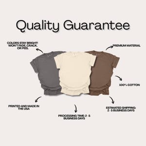May include: Three short-sleeved t-shirts in gray, cream, and brown are displayed. The image includes text stating "Quality Guarantee", "Colors stay bright! Won't fade, crack, or peel", "Premium Material", and "100% Cotton". The shirts are printed and made in the USA.