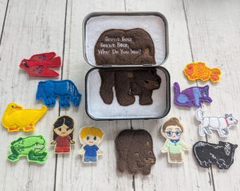 May include: A felted story set featuring a brown bear in a tin, with the text "Brown Bear, Brown Bear, What Do You See?" and various felt animal and character figures in red, blue, yellow, green, purple, white, and black.