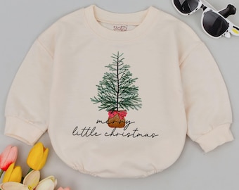 May include: A cream colored long-sleeved sweatshirt with a green Christmas tree graphic and the text "merry little christmas".