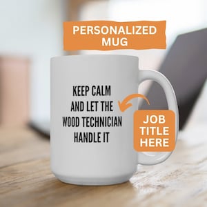 May include: White ceramic mug with the text "KEEP CALM AND LET THE WOOD TECHNICIAN HANDLE IT". The mug has a curved handle and an orange label that says "JOB TITLE HERE". An orange banner at the top says "PERSONALIZED MUG".