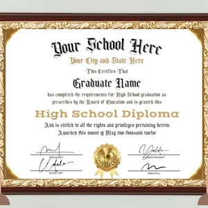 May include: A framed high school diploma with gold and brown decorative elements. The diploma features the text "Your School Here," "Graduate Name," and "High School Diploma." The date on the diploma is May two thousand twelve.