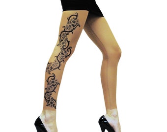 May include: A pair of sheer nude tights with a black floral tattoo design on the left leg. The tights are worn by a person wearing black heels.