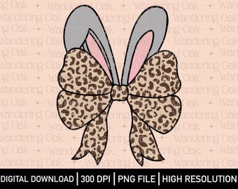 May include: A brown and tan leopard print bow with gray bunny ears. The bow is tied with a pink ribbon.