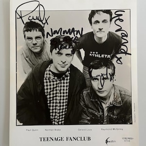 May include: Black and white photograph of the band Teenage Fanclub, featuring four members. The image is signed by the band members. The band's name is printed at the bottom, along with the names of the band members. The Columbia Records logo is also visible.