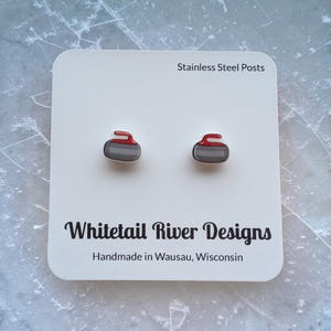 May include: A set of three ceramic mugs with a speckled, matte finish. The mugs are in shades of cream, light gray, and dark gray. Each mug has a simple, minimalist design, perfect for coffee or tea.