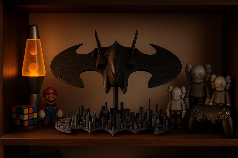 May include: A shelf display featuring a lava lamp, a Rubik's Cube, a Mario figurine, a Batman Batwing model, and KAWS figures. The Batwing is mounted above a cityscape base. The lava lamp is orange and black.
