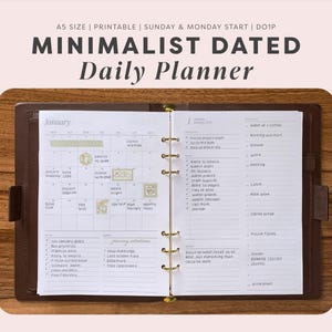 May include: A5 size daily planner with a brown leather binder. The open pages show a January calendar with handwritten notes, stickers, and a daily schedule list. Text includes A5 SIZE | PRINTABLE | SUNDAY & MONDAY START | D01P MINIMALIST DATED Daily Planner.