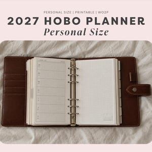 May include: A brown leather personal size planner with a six-ring metal binder mechanism. The open planner displays white pages with a grid layout and a weekly schedule. Text at the top reads: PERSONAL SIZE | PRINTABLE | WO2P 2027 HOBO PLANNER.