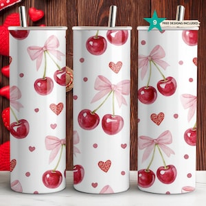 May include: Three stainless steel tumblers with a white background and a pattern of pink bows, red cherries, and red hearts. The tumblers are 20 ounces each.
