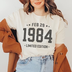 May include: A white t-shirt with black text that reads "FEB 29 ** 1984 - LIMITED EDITION -"