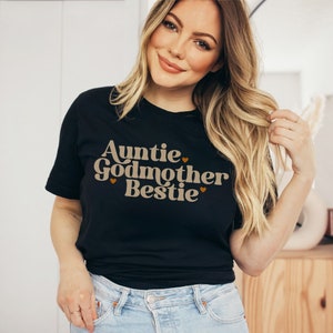 May include: Black t-shirt with the text "Auntie Godmother Bestie" in brown letters with small hearts.