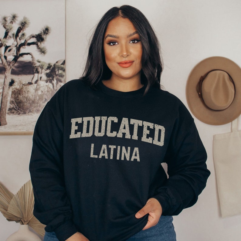 May include: Black sweatshirt with the text "EDUCATED LATINA" in a distressed white font.