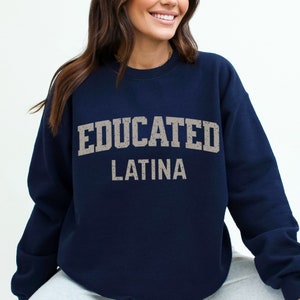 May include: Navy blue sweatshirt with the text "EDUCATED LATINA" in a distressed white font.