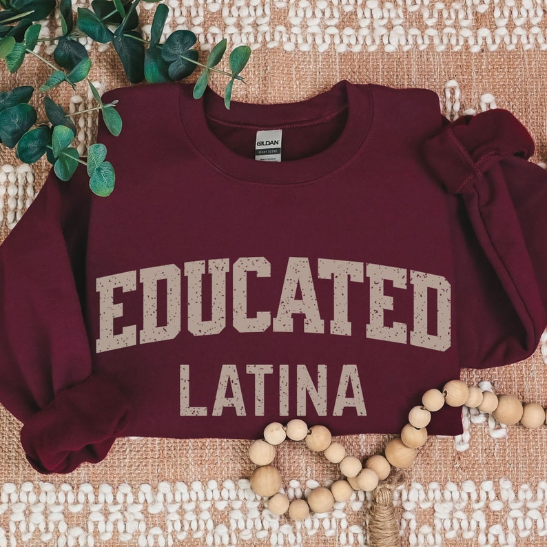 May include: Burgundy sweatshirt with the text "EDUCATED LATINA" in a distressed beige font.