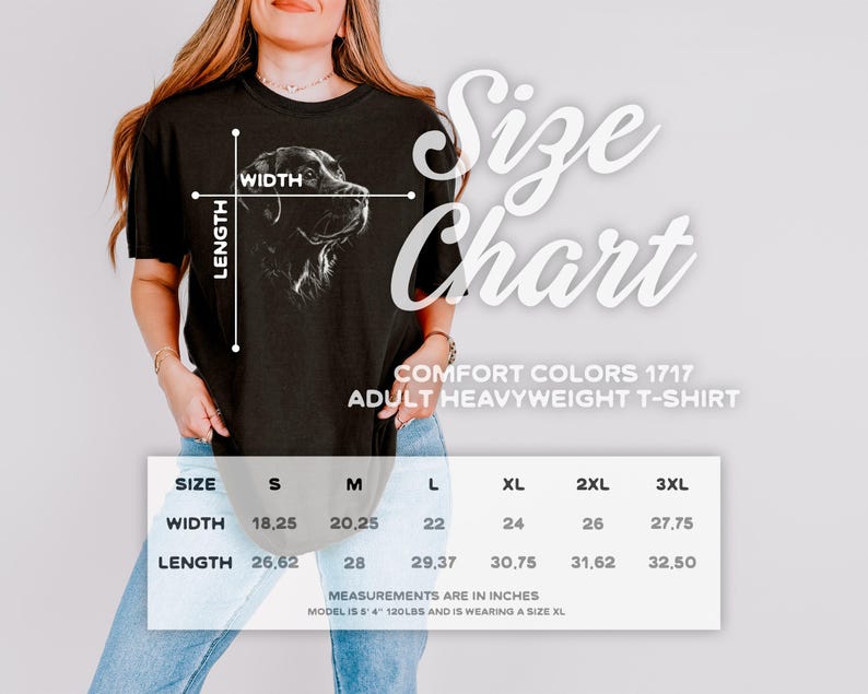 Op de afbeelding: Een zwart t-shirt met korte mouwen en een witte lijntekening van een hondenkop. De afbeelding bevat een maattabel met breedte- en lengtematen in inches voor de maten S tot 3XL, gelabeld als Comfort Colors 1717 Adult Heavyweight T-Shirt.