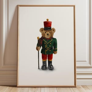 May include: A framed wall art print featuring a brown teddy bear dressed as a toy soldier. The bear wears a red hat, a green jacket with gold buttons, a plaid scarf, red trousers, and black boots, while holding a thin black staff with a gold top.
